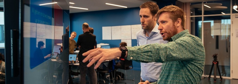 Person pointing towards screen