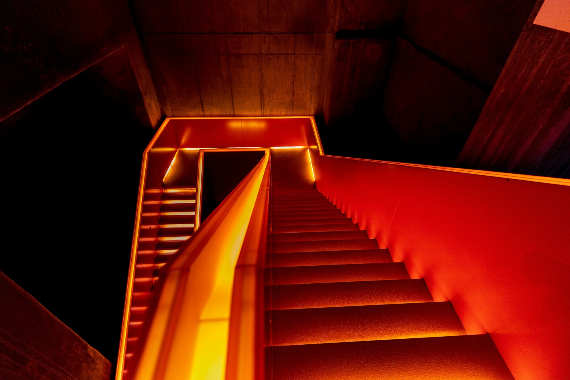 Abstract orange-lit staircase, AE brand visual