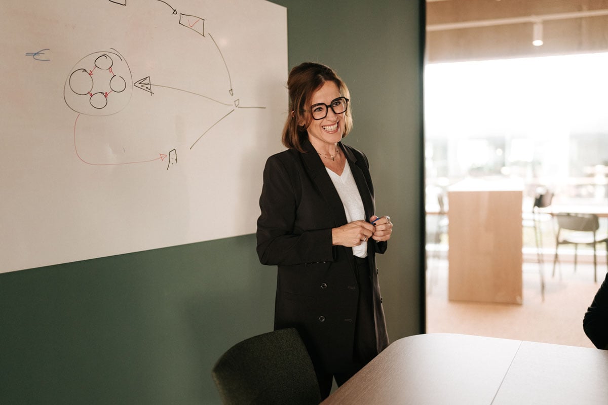 An AE consultant explaining a diagram on a whiteboard