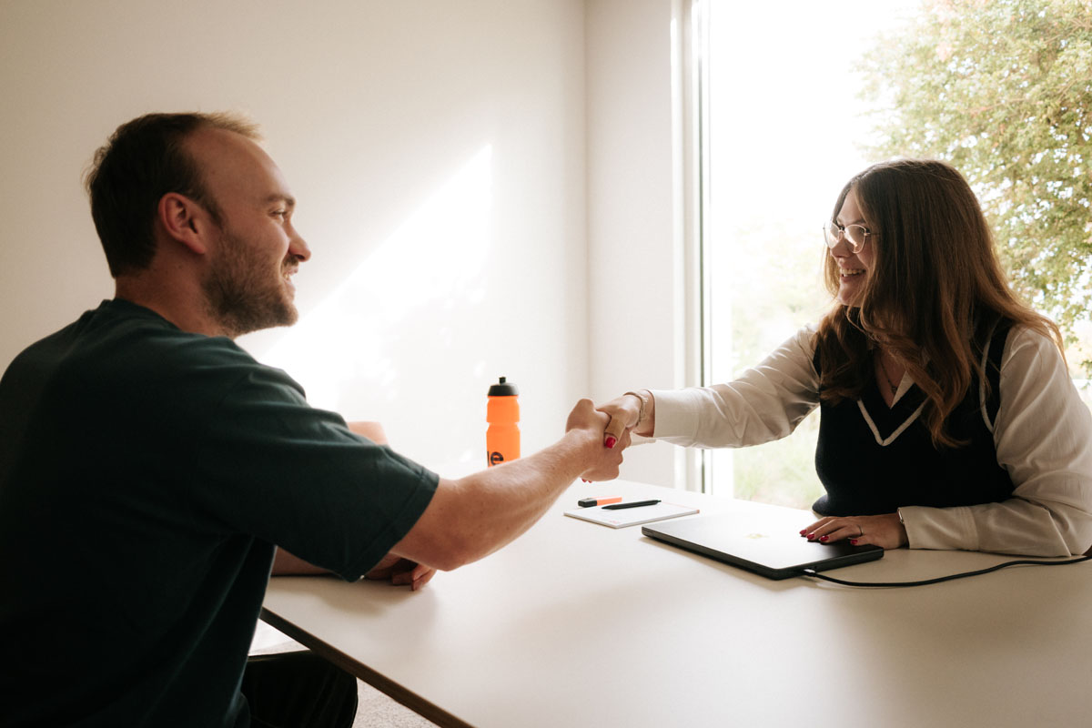 Handshake across a desk at the start of a new collaboration
